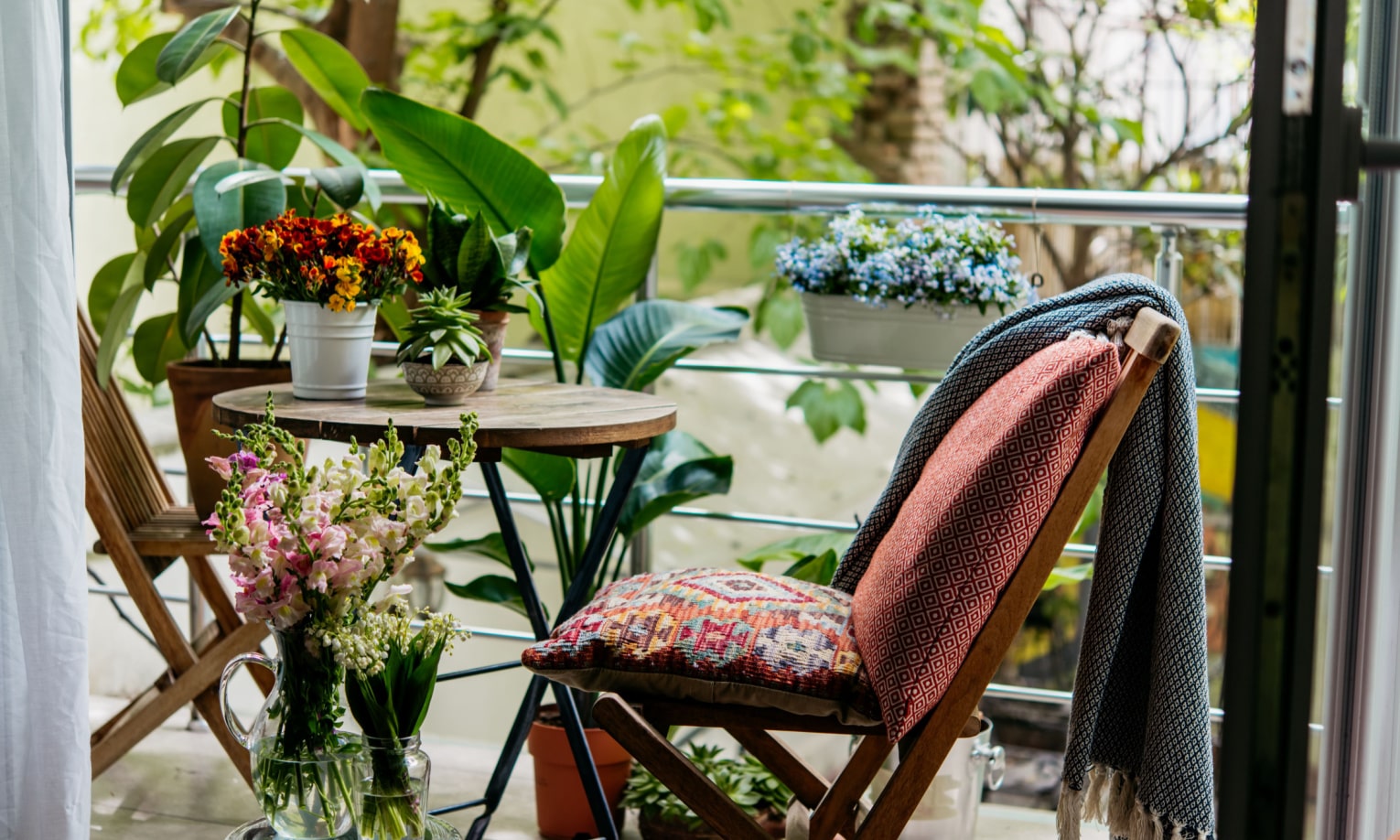 уютный балкон с мебелью украшен растениями