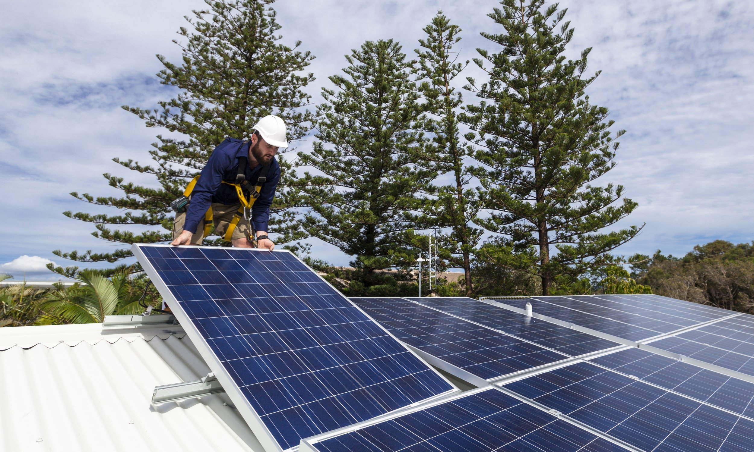 мужчина устанавливает солнечные электростанции для дома